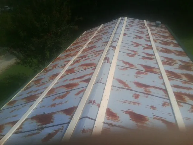 Rusted metal roof panels with new wood purlins before replacement — Storm Damage Roof Repair in Indio by Roofing Brothers